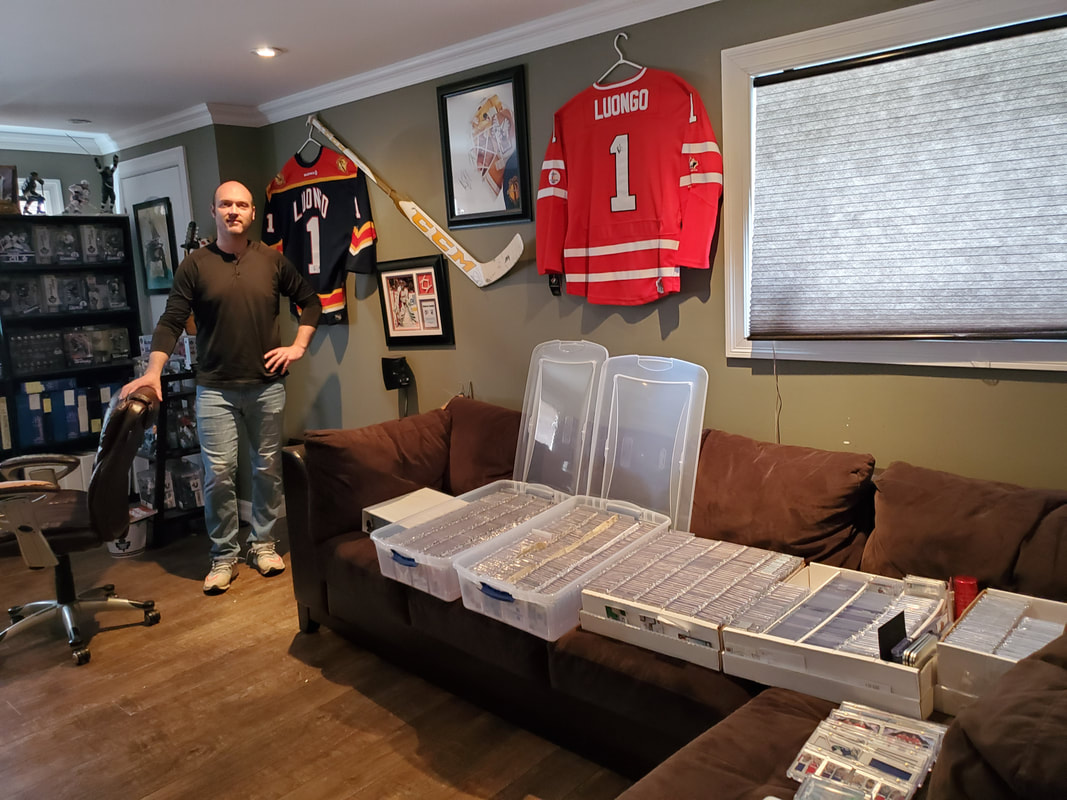 A collector standing with his Roberto Luongo NHL hockey card collection.